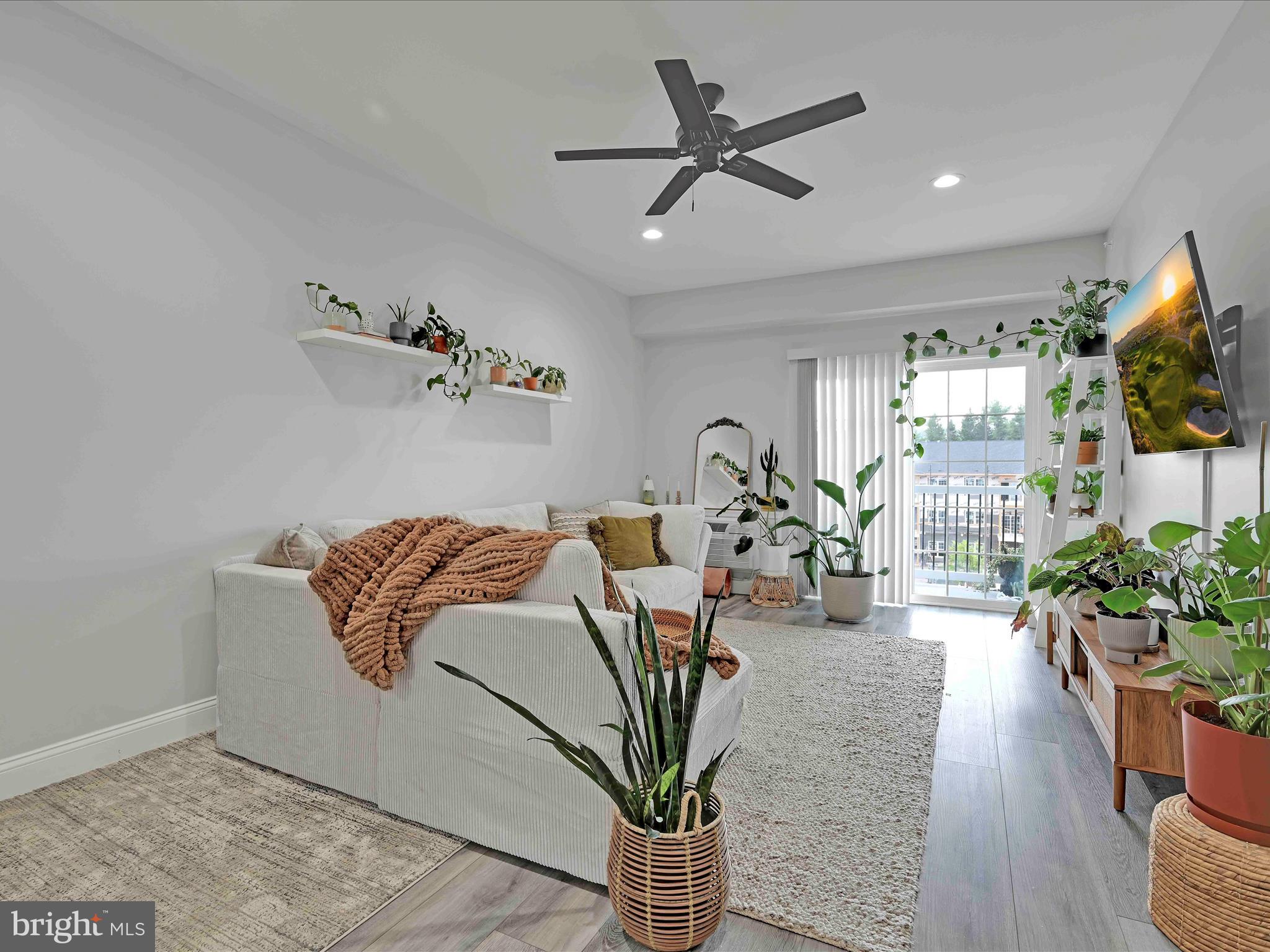 500-800 Paramount Boulevard, Unit 101312 Orwigsburg, PA 17961 - Photo 16 of 66 a living room with furniture a chandelier and a flat screen tv