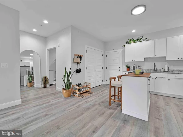 a kitchen with white cabinets and white appliances