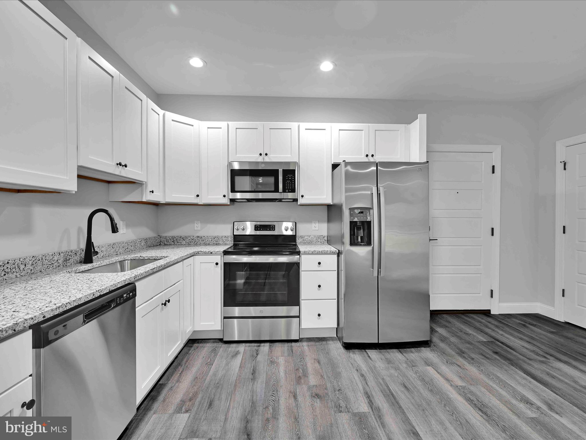 500-800 Paramount Boulevard, Unit 101312 Orwigsburg, PA 17961 - Photo 24 of 66 a kitchen with stainless steel appliances granite countertop a refrigerator sink and stove