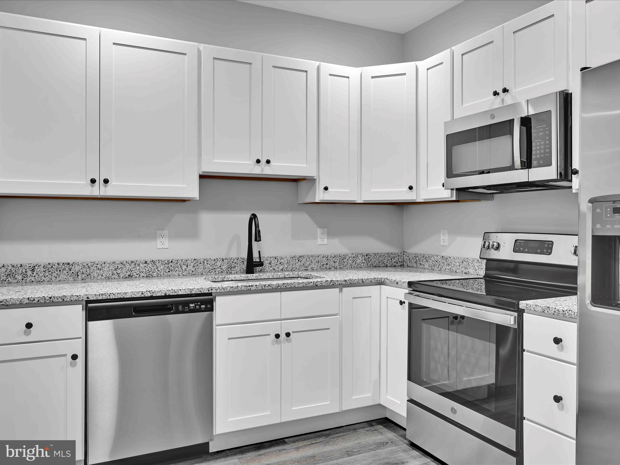 500-800 Paramount Boulevard, Unit 101312 Orwigsburg, PA 17961 - Photo 25 of 66 a kitchen with white cabinets and white appliances