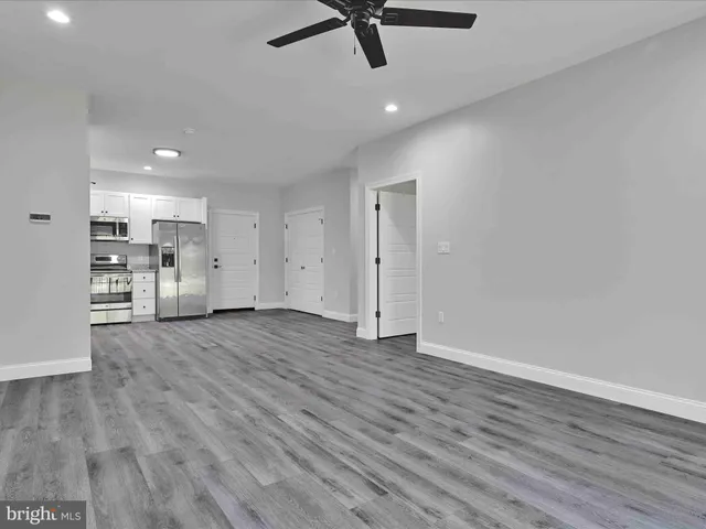 a bathroom with a granite countertop sink toilet a mirror and shower