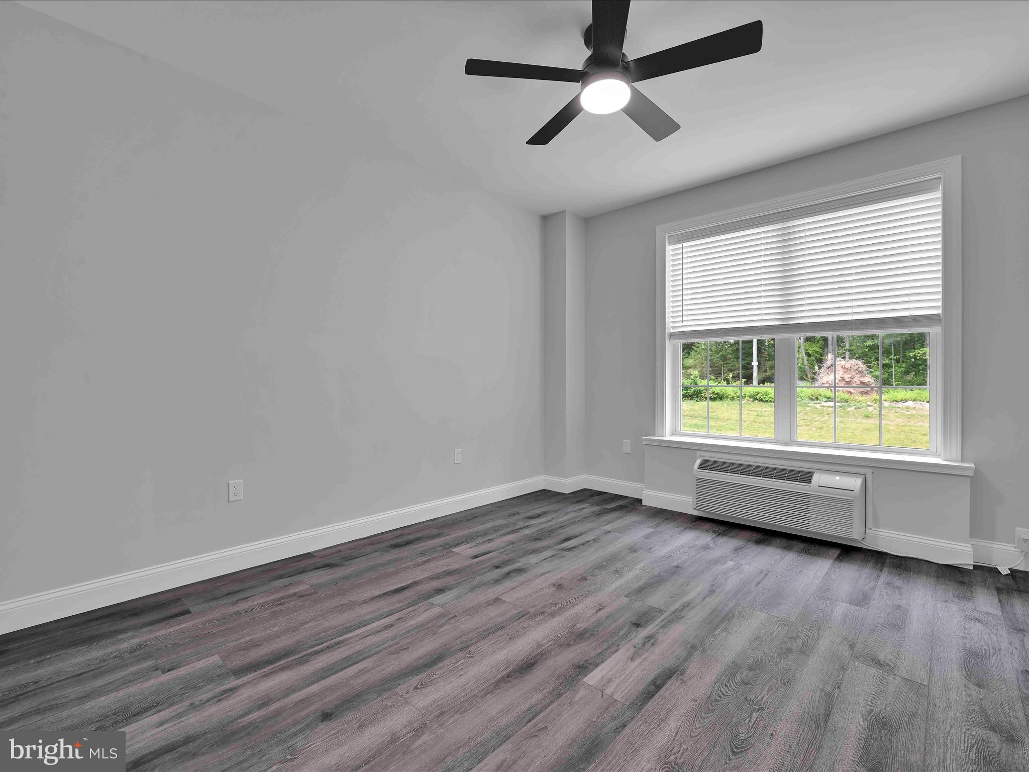 500-800 Paramount Boulevard, Unit 101312 Orwigsburg, PA 17961 - Photo 29 of 66 an empty room with wooden floor and windows