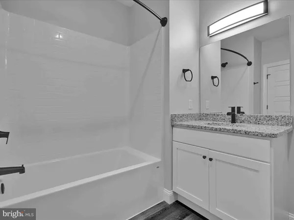 a large kitchen with a table and chairs