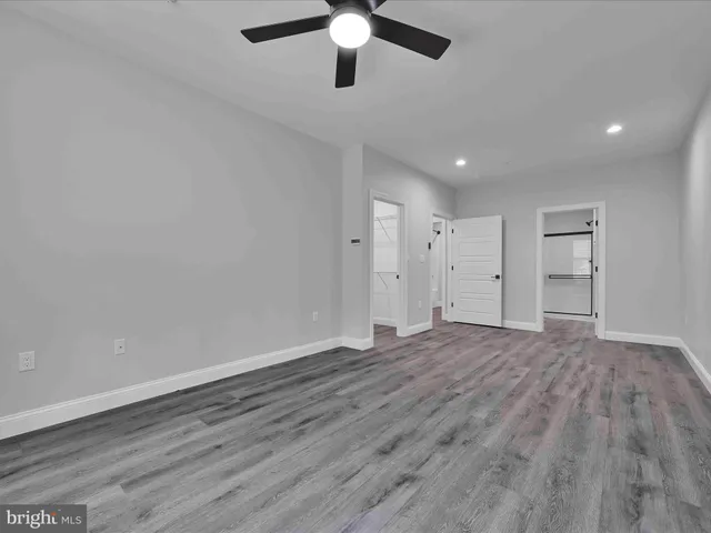 a large kitchen with stainless steel appliances granite countertop a stove a sink and white cabinets