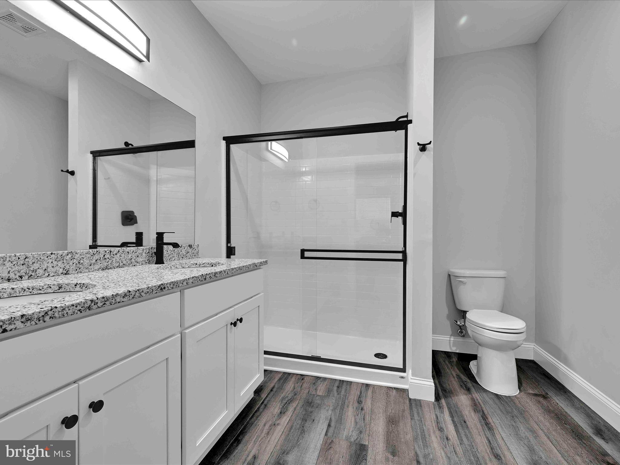 500-800 Paramount Boulevard, Unit 101312 Orwigsburg, PA 17961 - Photo 37 of 66 a bathroom with a granite countertop sink toilet a mirror and shower