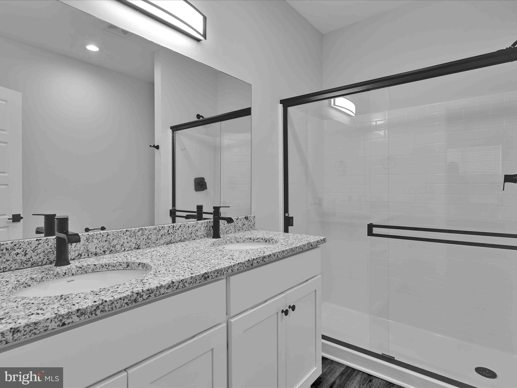500-800 Paramount Boulevard, Unit 101312 Orwigsburg, PA 17961 - Photo 38 of 66 a bathroom with a granite countertop sink and a mirror
