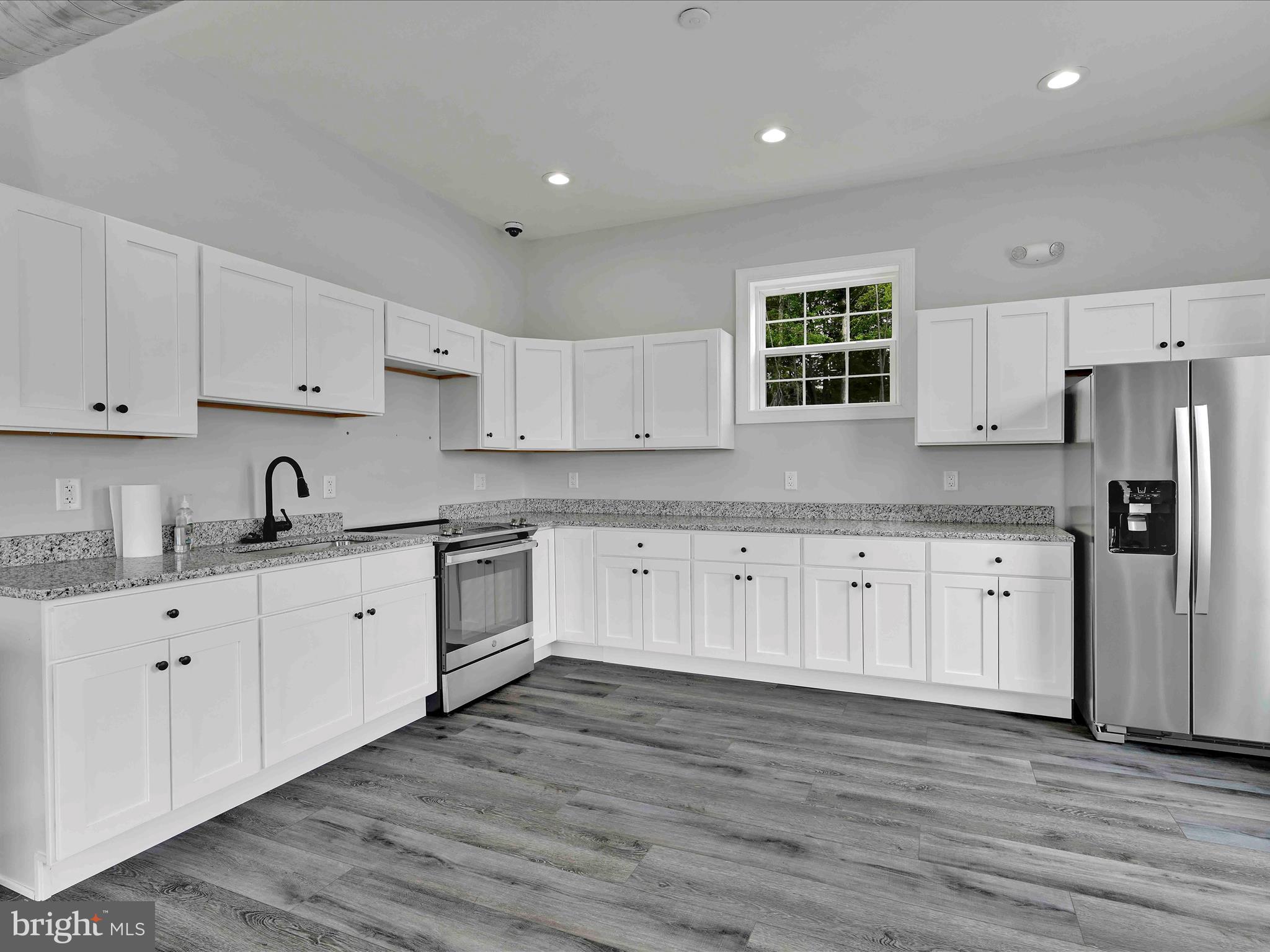 500-800 Paramount Boulevard, Unit 101312 Orwigsburg, PA 17961 - Photo 48 of 66 a large kitchen with stainless steel appliances granite countertop a stove a sink and white cabinets