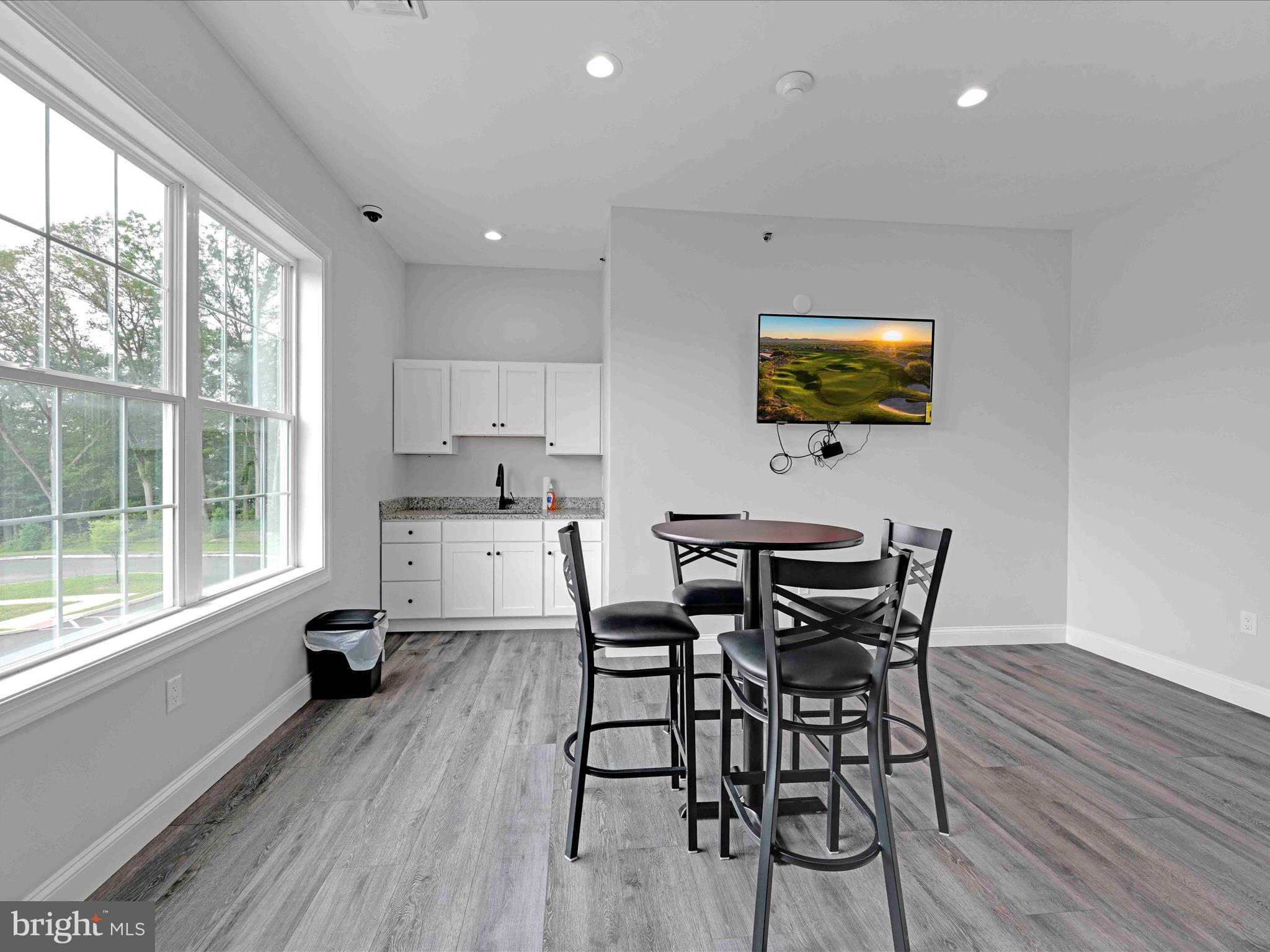500-800 Paramount Boulevard, Unit 101312 Orwigsburg, PA 17961 - Photo 53 of 66 a view of a dining room with furniture and a flat screen tv