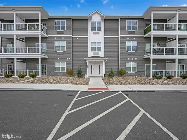a kitchen with stainless steel appliances granite countertop a sink and a refrigerator