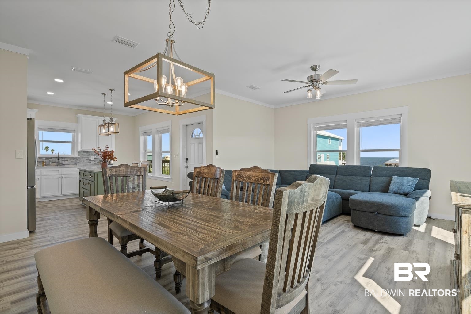 2586 Muscogee Road Gulf Shores, AL 36542 - Photo 16 of 55 Dining room with light wood-type flooring, ceiling fan with notable chandelier, ornamental molding, and sink