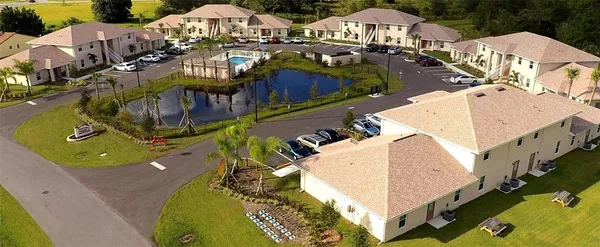 an aerial view of a house with swimming pool outdoor seating