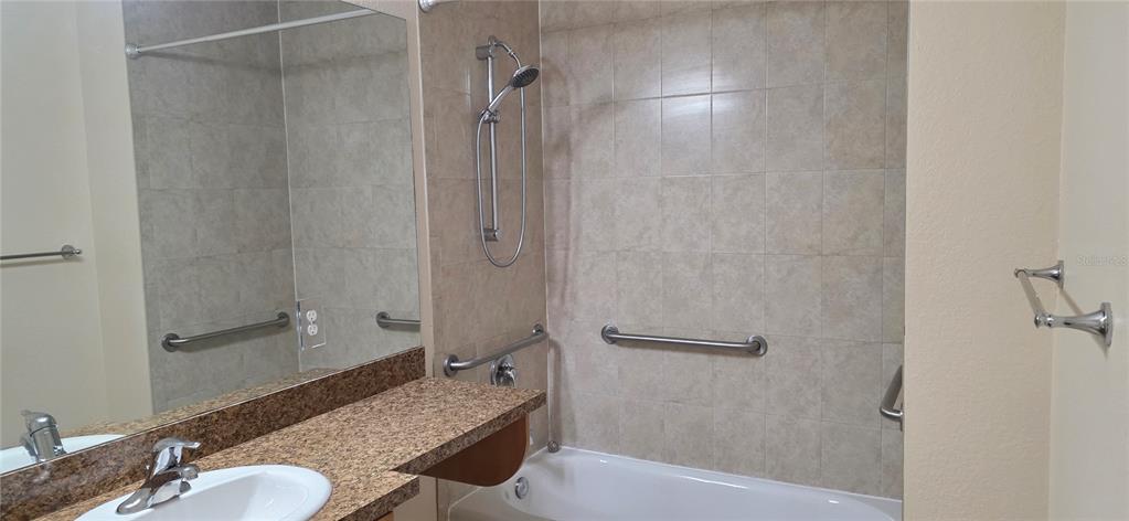 26172 Explorer Road, Unit 4 Punta Gorda, FL 33983 - Photo 9 of 11 a bathroom with a granite countertop shower and a sink