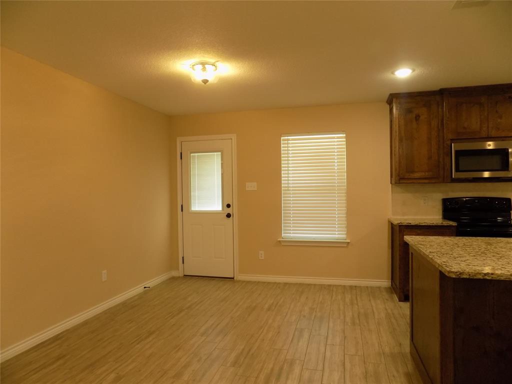 506 Pecan Tree Court Poolville, TX 76487 - Photo 14 of 36 Dining just off kitchen area, as well as in-kitchen eating at island
