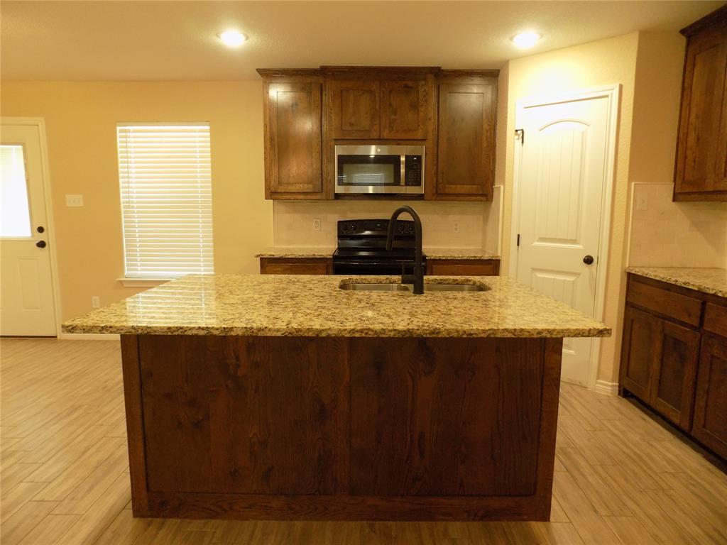 506 Pecan Tree Court Poolville, TX 76487 - Photo 16 of 36 Wonderful kitchen island with large under cabinet double stainless sink