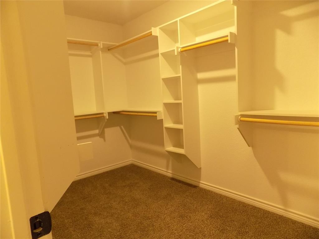 506 Pecan Tree Court Poolville, TX 76487 - Photo 25 of 36 Amazing primary bedroom's walk-in closet, so much space and shelves