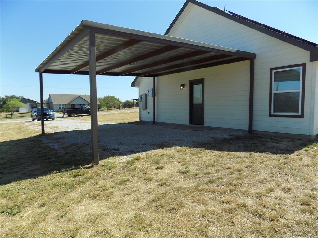 506 Pecan Tree Court Poolville, TX 76487 - Photo 3 of 36 Attached carport with third entry door