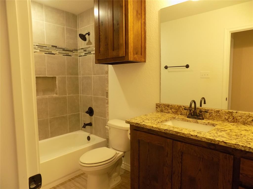 506 Pecan Tree Court Poolville, TX 76487 - Photo 6 of 36 Guest bathroom with lovely granite counter tops and tile work