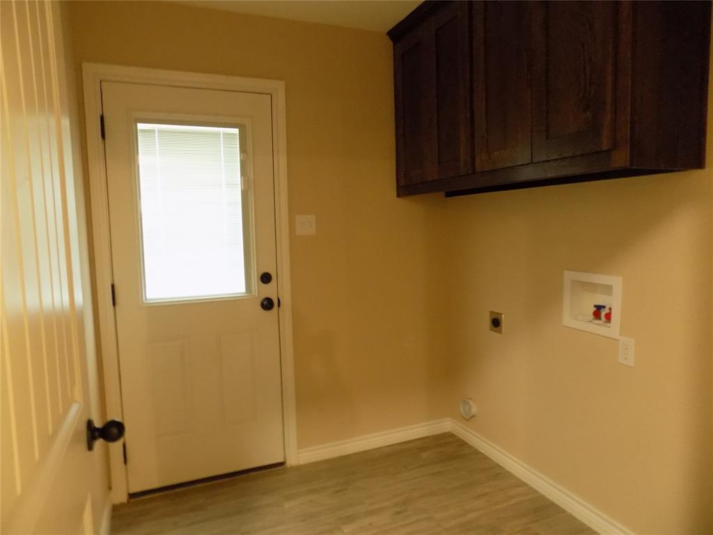 506 Pecan Tree Court Poolville, TX 76487 - Photo 9 of 36 Separate utility room with handy cabinets
