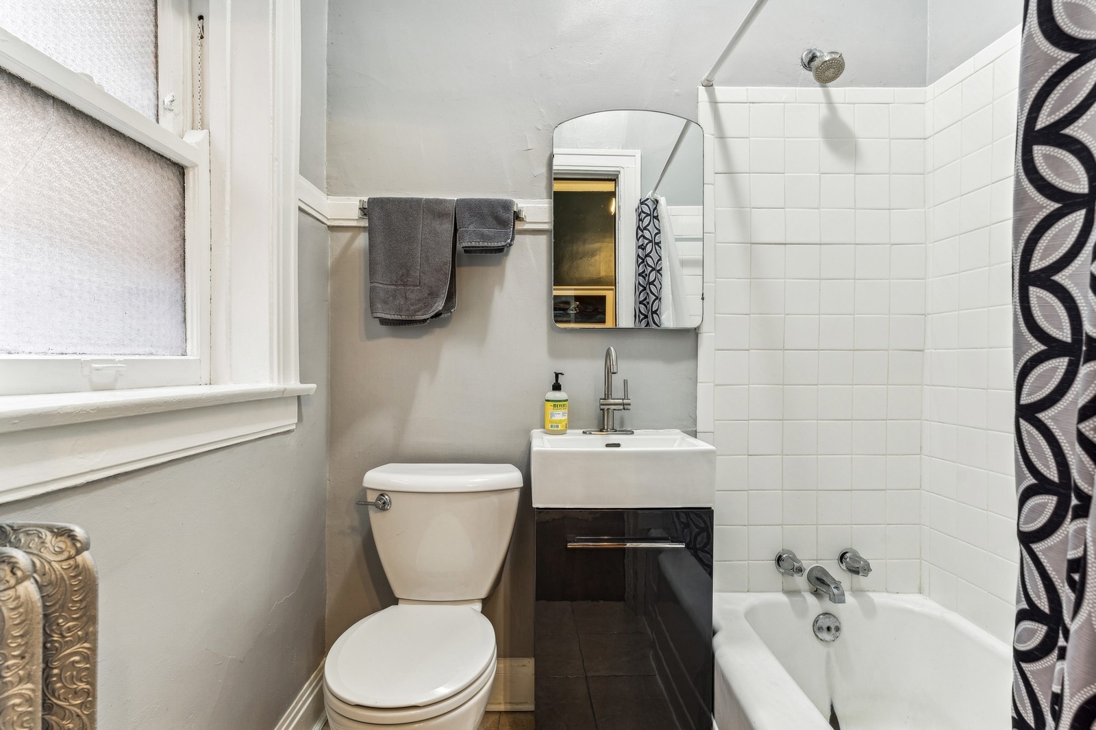 851 East Drexel Square, Unit 1A Chicago, IL 60615 - Photo 20 of 21 a bathroom with a toilet a sink and mirror