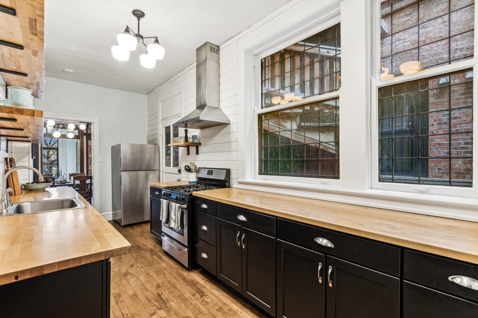 851 East Drexel Square, Unit 1A Chicago, IL 60615 - Photo 7 of 21 a kitchen with stainless steel appliances sink stove and refrigerator