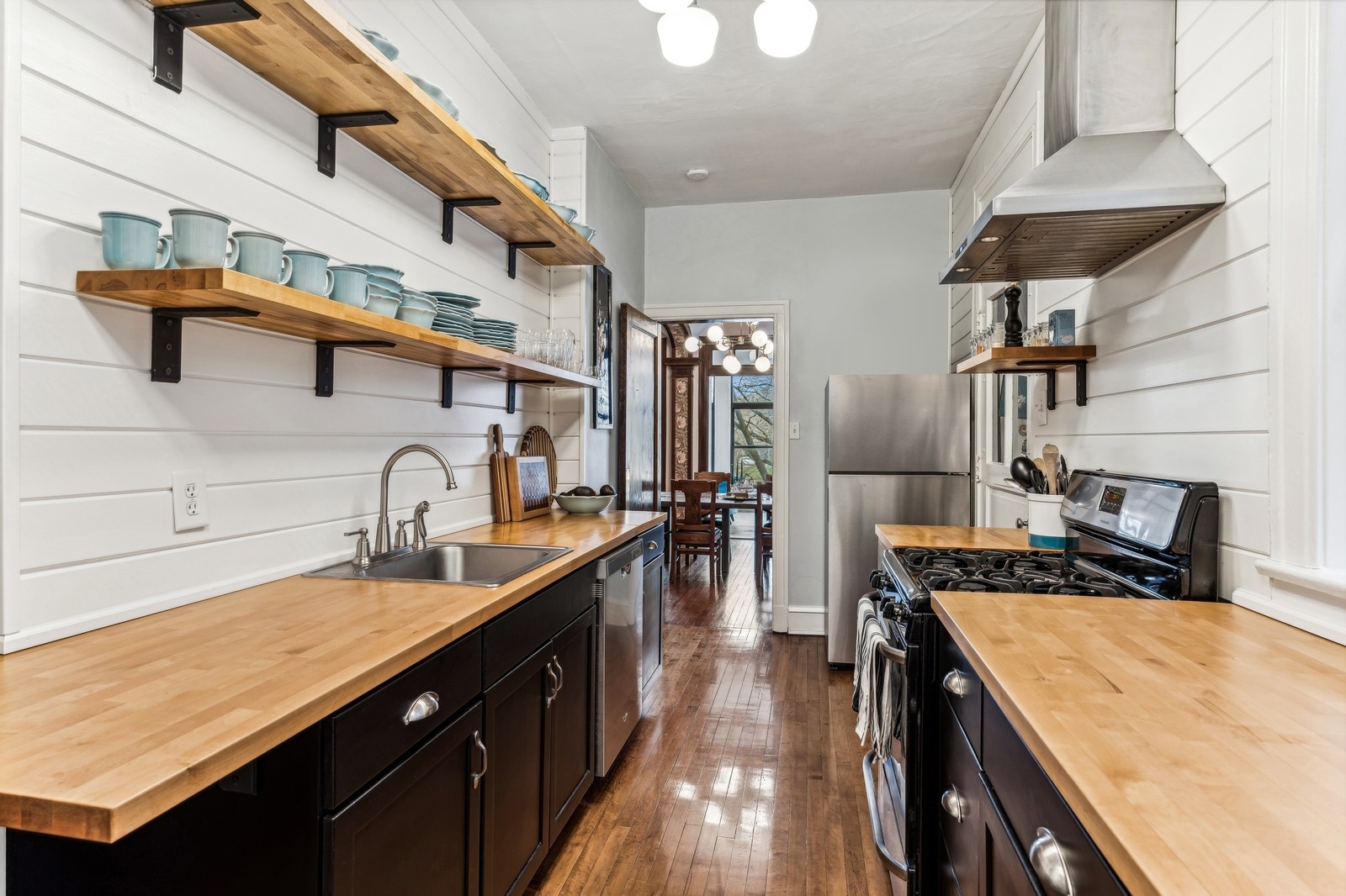 851 East Drexel Square, Unit 1A Chicago, IL 60615 - Photo 8 of 21 a kitchen with stainless steel appliances granite countertop a sink and stove