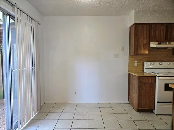 a kitchen with stainless steel appliances granite countertop a refrigerator a stove and a sink