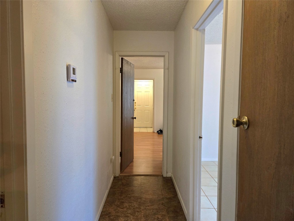 1404 Matthews Lane, Unit A Austin, TX 78745 - Photo 6 of 13 a view of a hallway with a wooden door