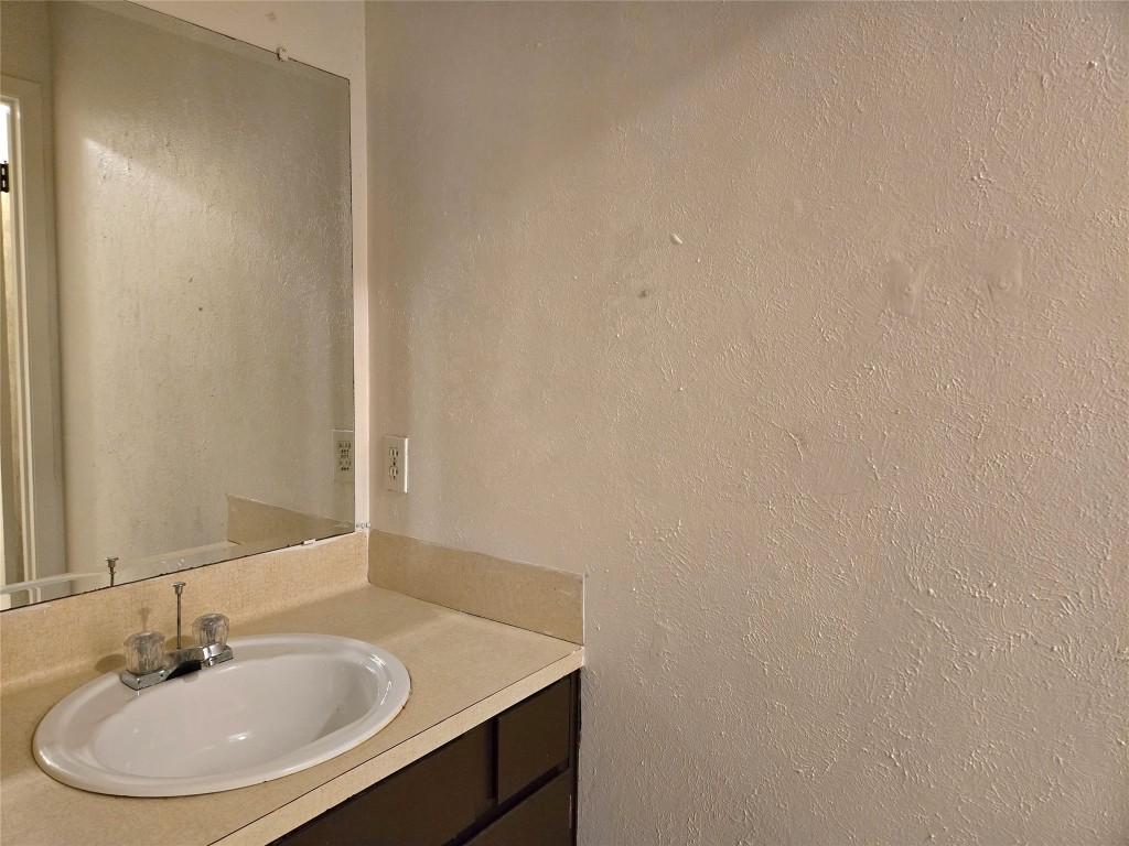 1404 Matthews Lane, Unit A Austin, TX 78745 - Photo 7 of 13 a bathroom with a sink and a mirror