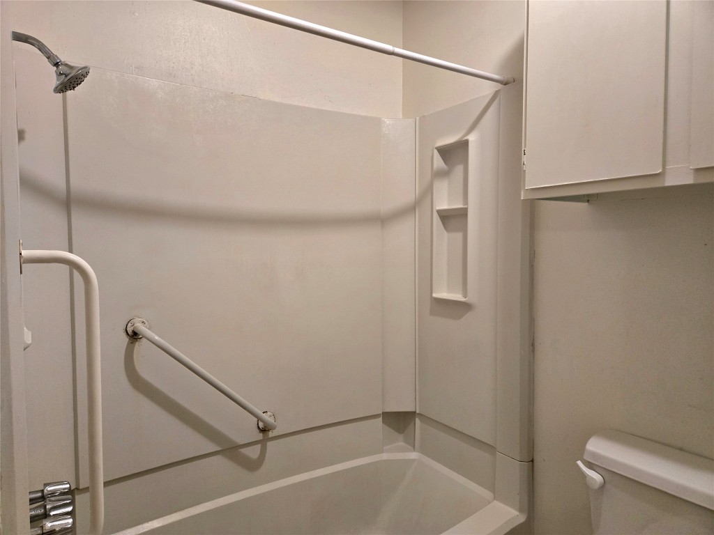 1404 Matthews Lane, Unit A Austin, TX 78745 - Photo 10 of 13 a bathroom with a shower and a bath tub