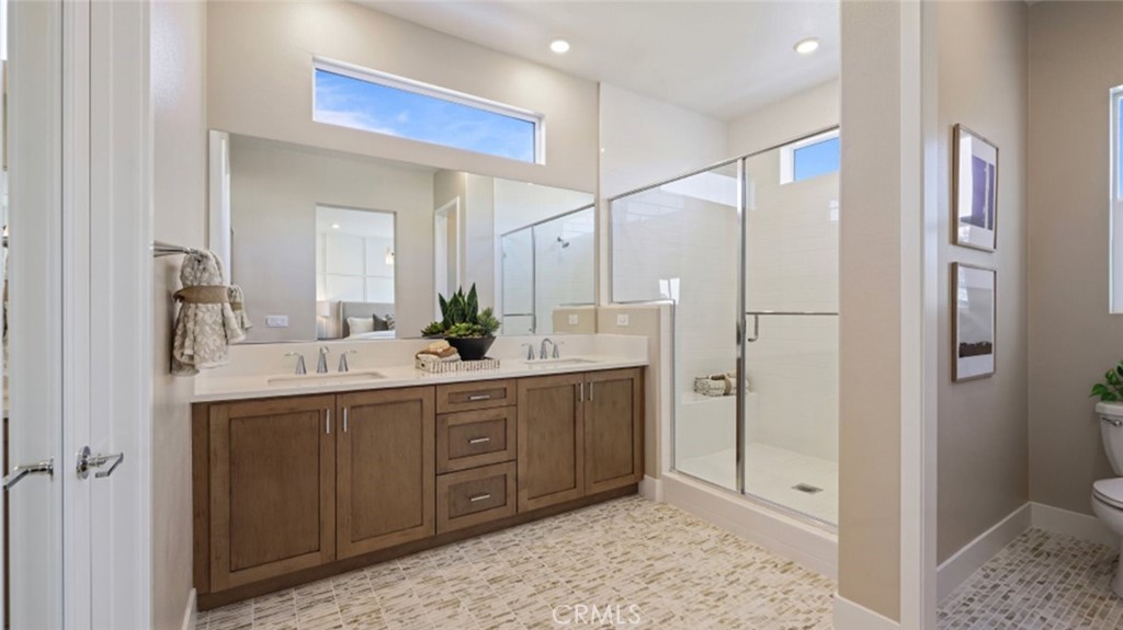 105 Proctor Irvine, CA 92618 - Photo 13 of 33 a spacious bathroom with a shower sink and mirror
