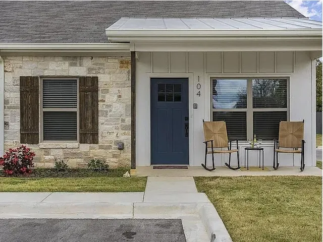 a front view of a house with a yard