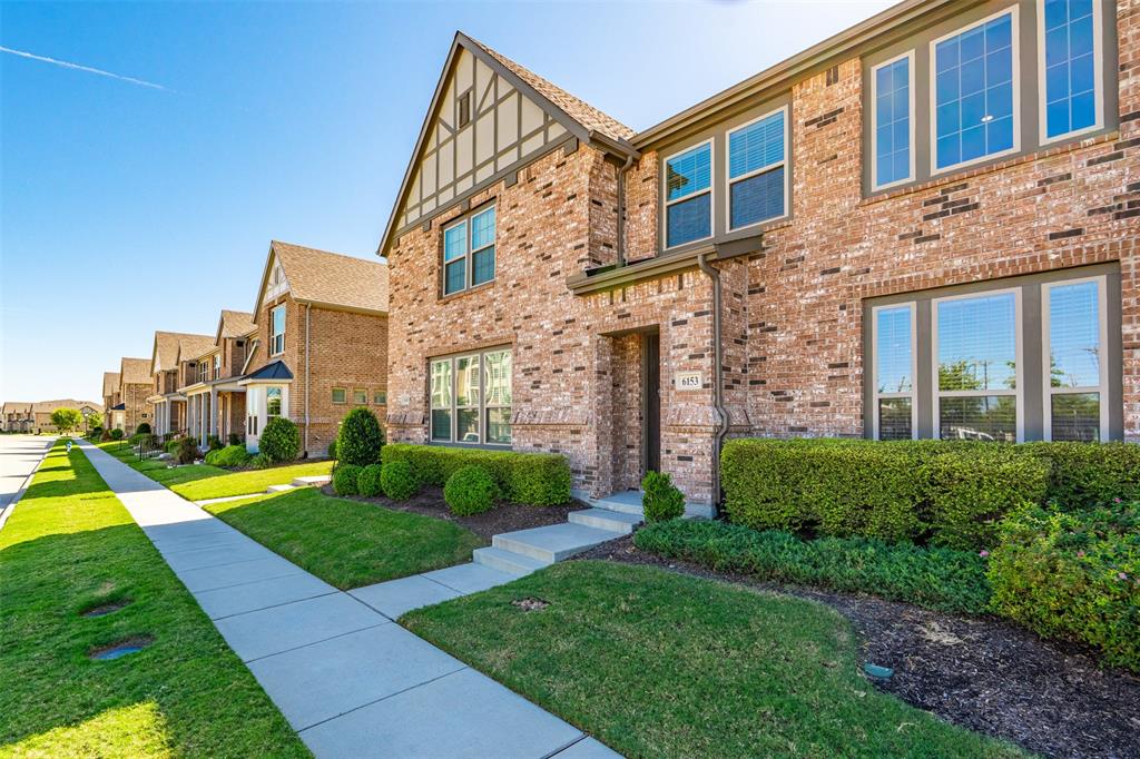 a view of a brick building next to a yard