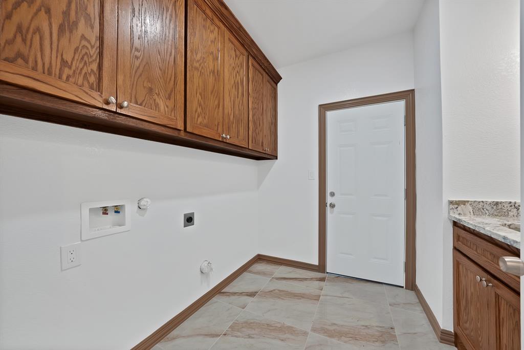 206 Hix Road Cleburne, TX 76031 - Photo 12 of 40 Washroom with hookup for a gas dryer, cabinet space, hookup for an electric dryer, and washer hookup