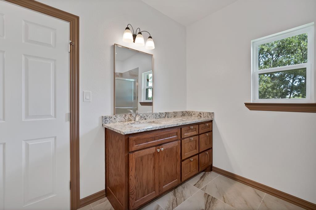206 Hix Road Cleburne, TX 76031 - Photo 13 of 40 Bathroom featuring vanity, a stall shower, and light marble finish floors