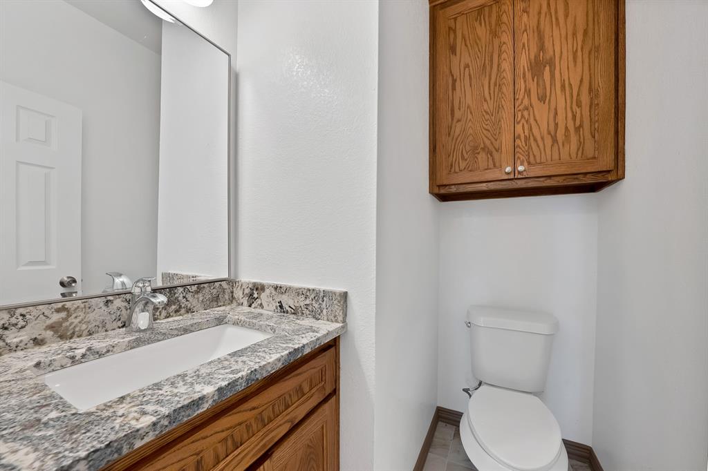 206 Hix Road Cleburne, TX 76031 - Photo 14 of 40 Half bathroom featuring vanity and toilet