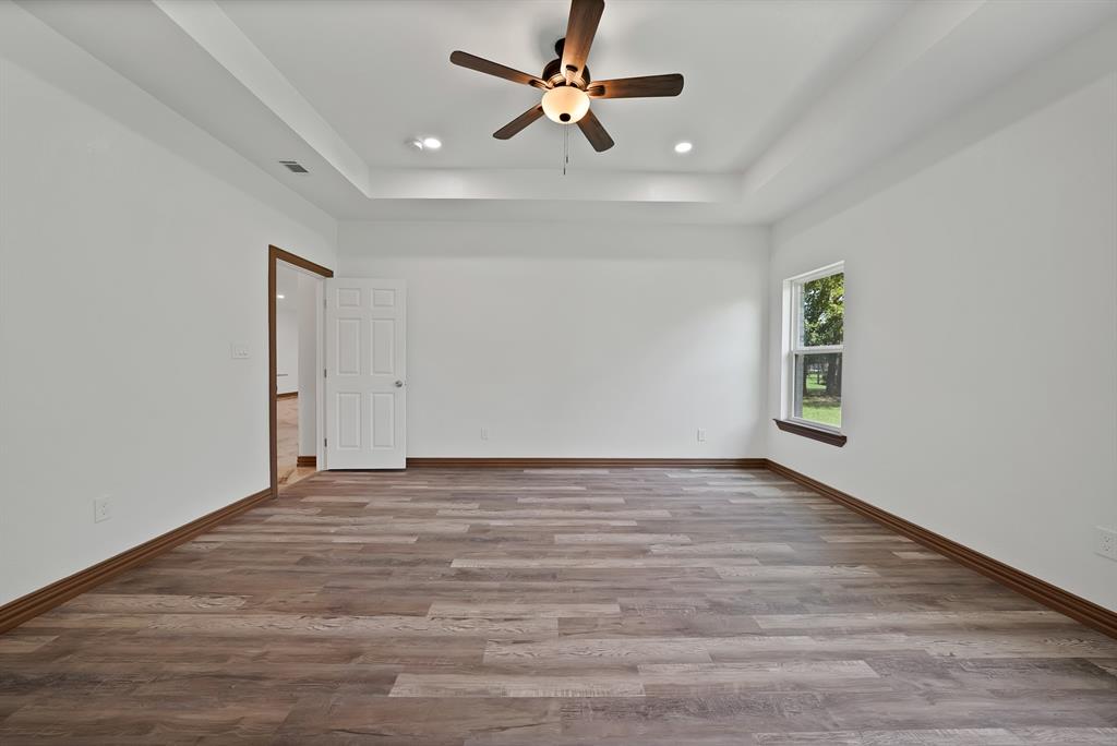 206 Hix Road Cleburne, TX 76031 - Photo 28 of 40 Spare room featuring a raised ceiling, light wood-type flooring, recessed lighting, and a ceiling fan