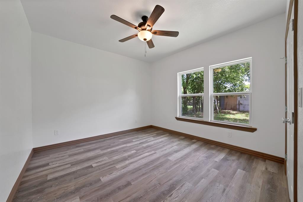 206 Hix Road Cleburne, TX 76031 - Photo 30 of 40 Empty room featuring light wood finished floors and a ceiling fan
