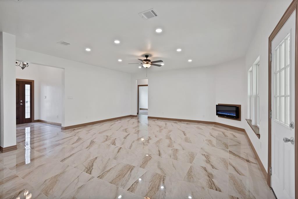 206 Hix Road Cleburne, TX 76031 - Photo 37 of 40 Unfurnished living room with recessed lighting, light marble finish floors, and a ceiling fan