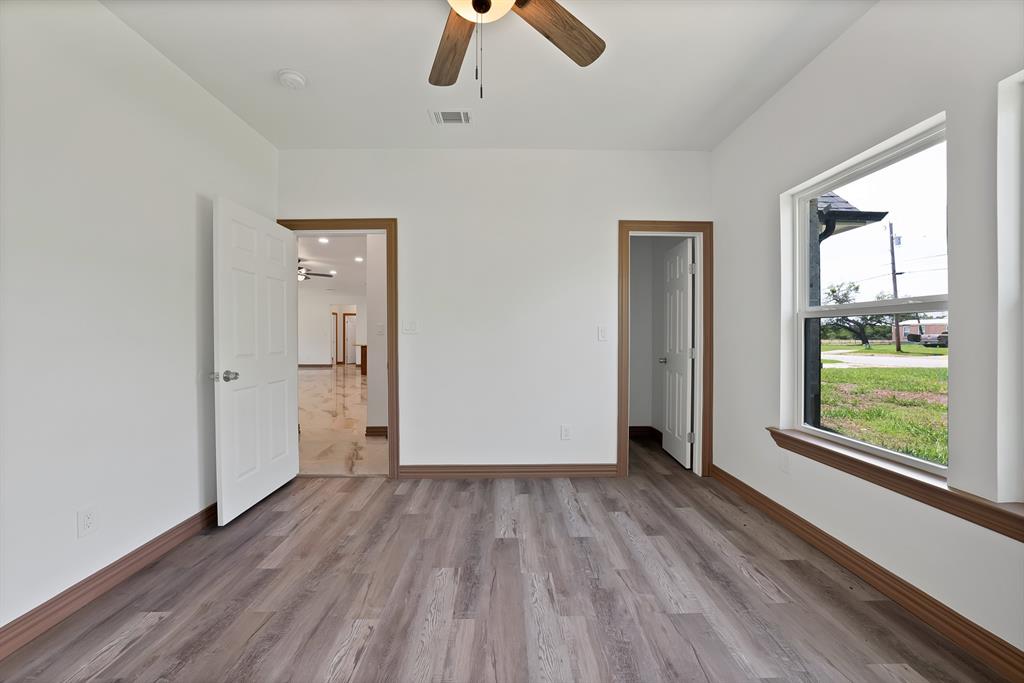 206 Hix Road Cleburne, TX 76031 - Photo 38 of 40 Unfurnished bedroom with light wood-style flooring, a ceiling fan, and a spacious closet