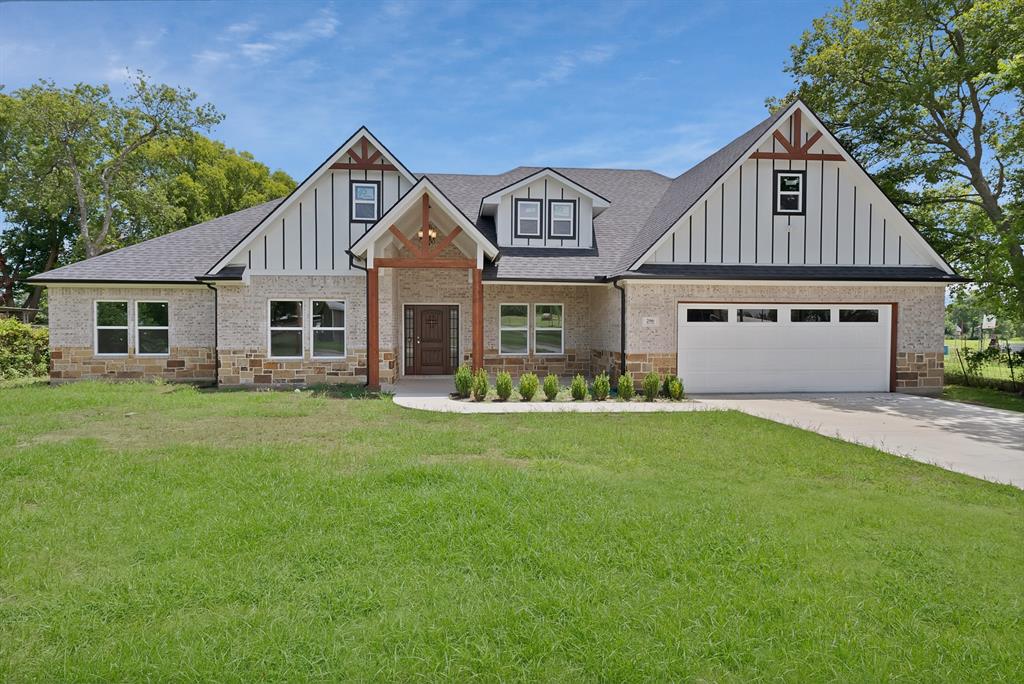 206 Hix Road Cleburne, TX 76031 - Photo 5 of 40 View of front of property featuring a front yard, board and batten siding, a shingled roof, and a garage