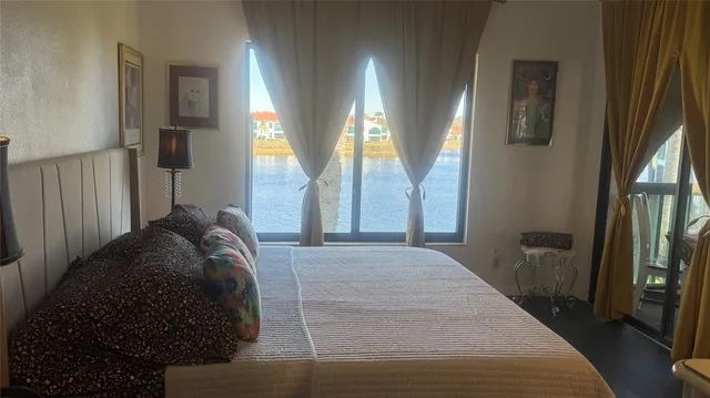 a bed sitting in a bedroom next to a window