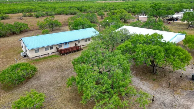 an aerial view of a house having yard