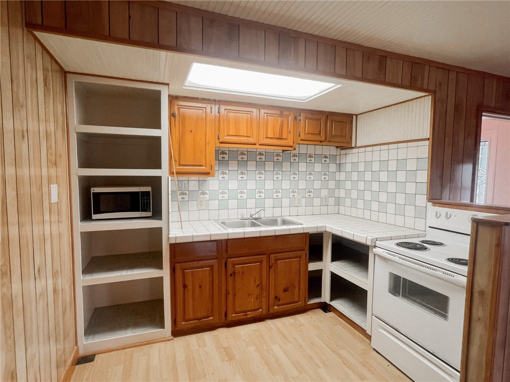 156 Naylor Road Calliham, TX 78007 - Photo 13 of 28 a kitchen with a sink stove and cabinets