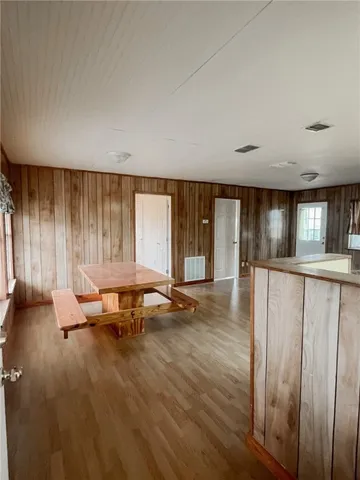 a living room with a bed furniture and next to a window