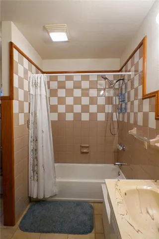 a bathroom with a toilet and a mirror