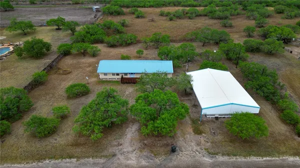 an aerial view of a house with a yard and lake view