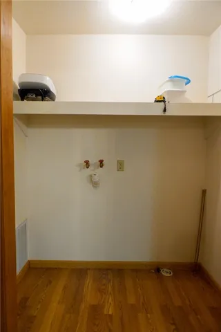 a living room with furniture a flat screen tv and a window