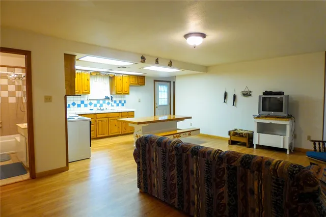 a view of a hallway to rooms and stairs