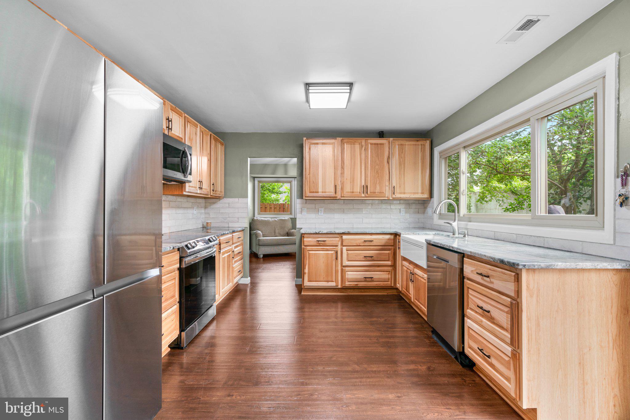 5367 Flight Feather Columbia, MD 21045 - Photo 2 of 42 a kitchen with stainless steel appliances a refrigerator sink and wooden cabinets