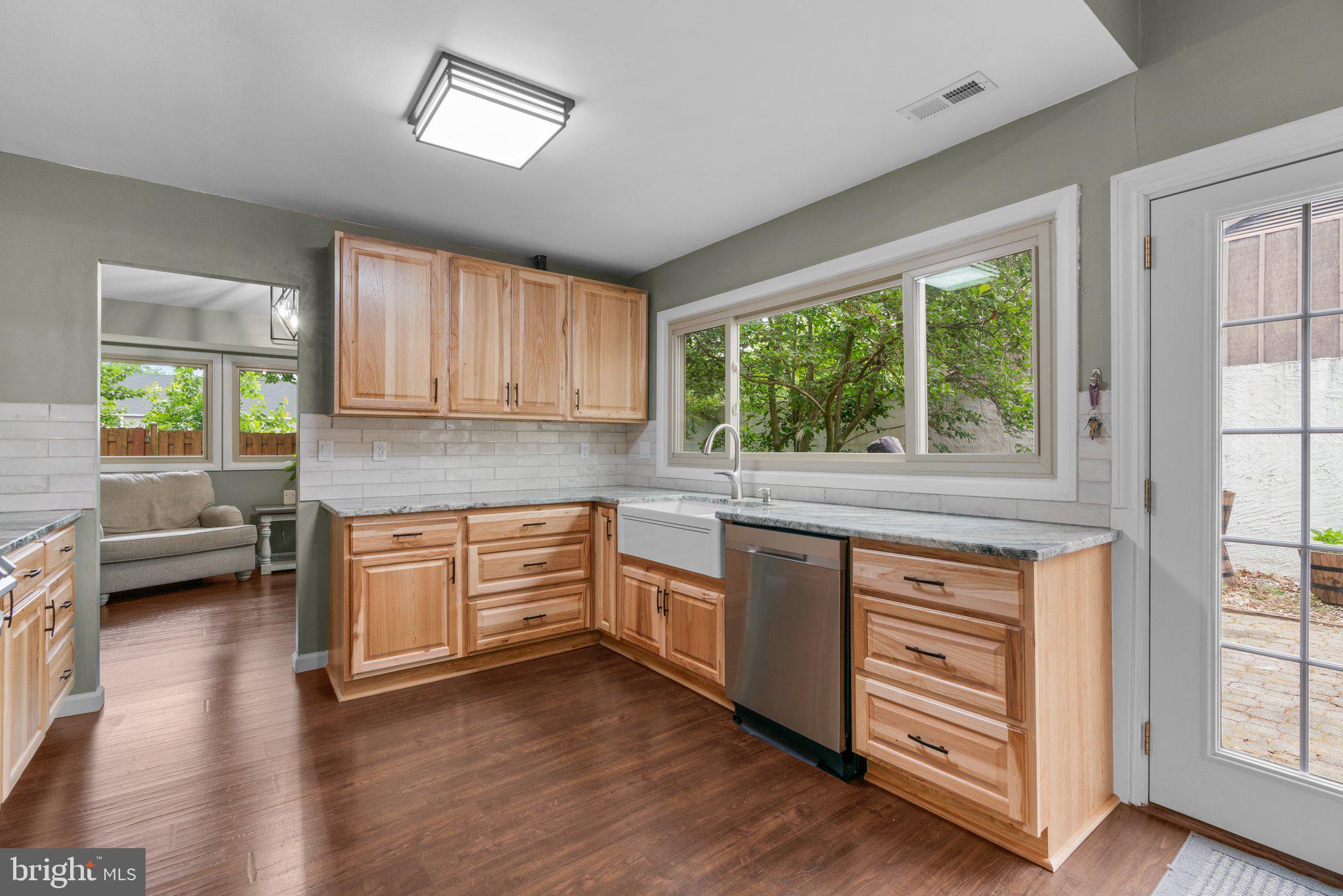 5367 Flight Feather Columbia, MD 21045 - Photo 7 of 42 a kitchen with stainless steel appliances granite countertop wooden cabinets a stove a sink and a large window